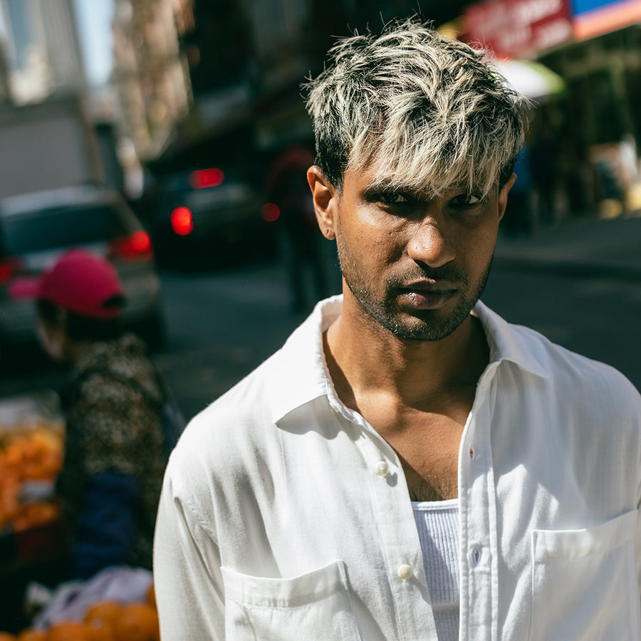 A portrait photo of a man in a white button down shirt.