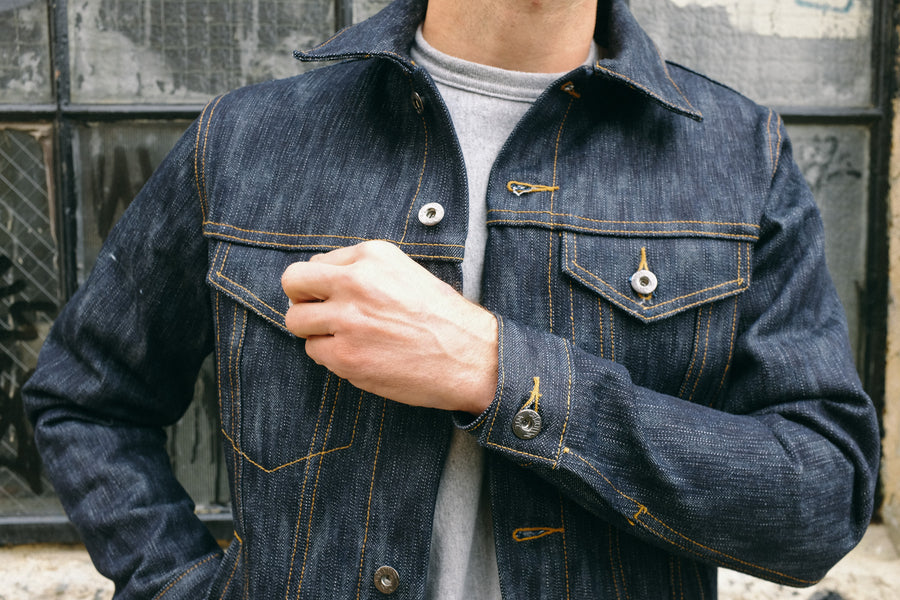 A model adjusts the pocket on a 3sixteen denim jacket.