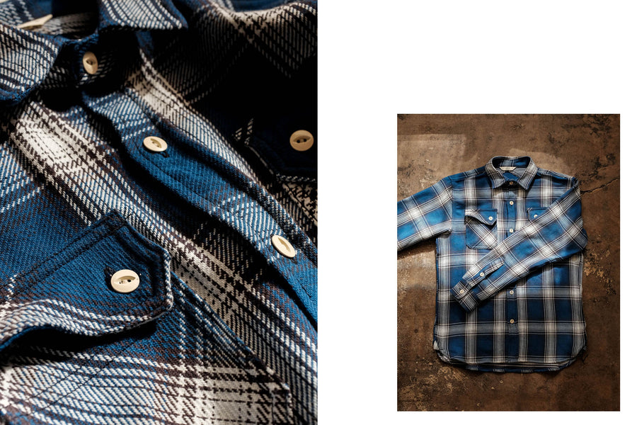 Detail shots of the blue check flannel by 3sixteen show the angled pocket flag and the overall look of the shirt laying on a concrete floor.