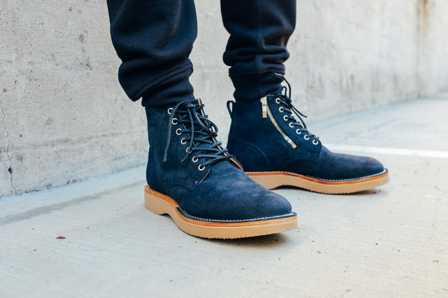 A detailed shot of the 3sixteen x Viberg Service Boots, worn with black sweatpants.