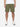 A person standing against a white background wearing olive green drawstring shorts and a white t-shirt, paired with white sneakers.