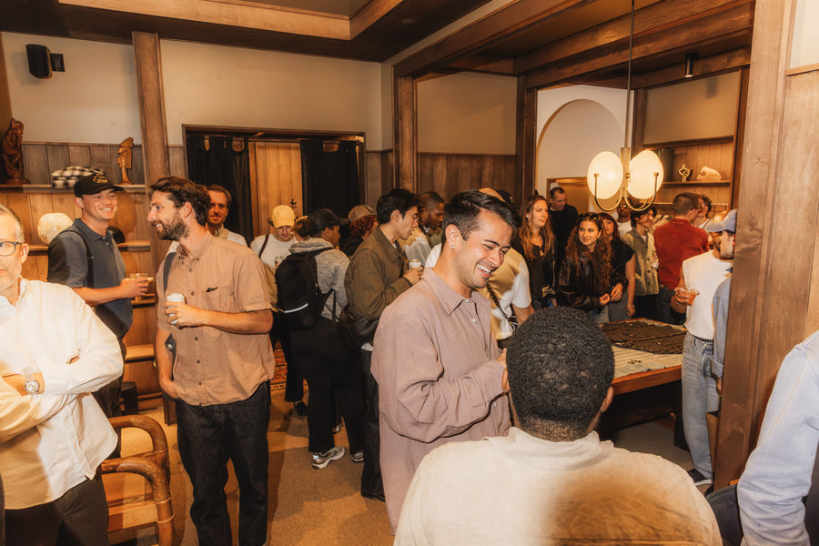 A bunch of people in a dark wood room partying.
