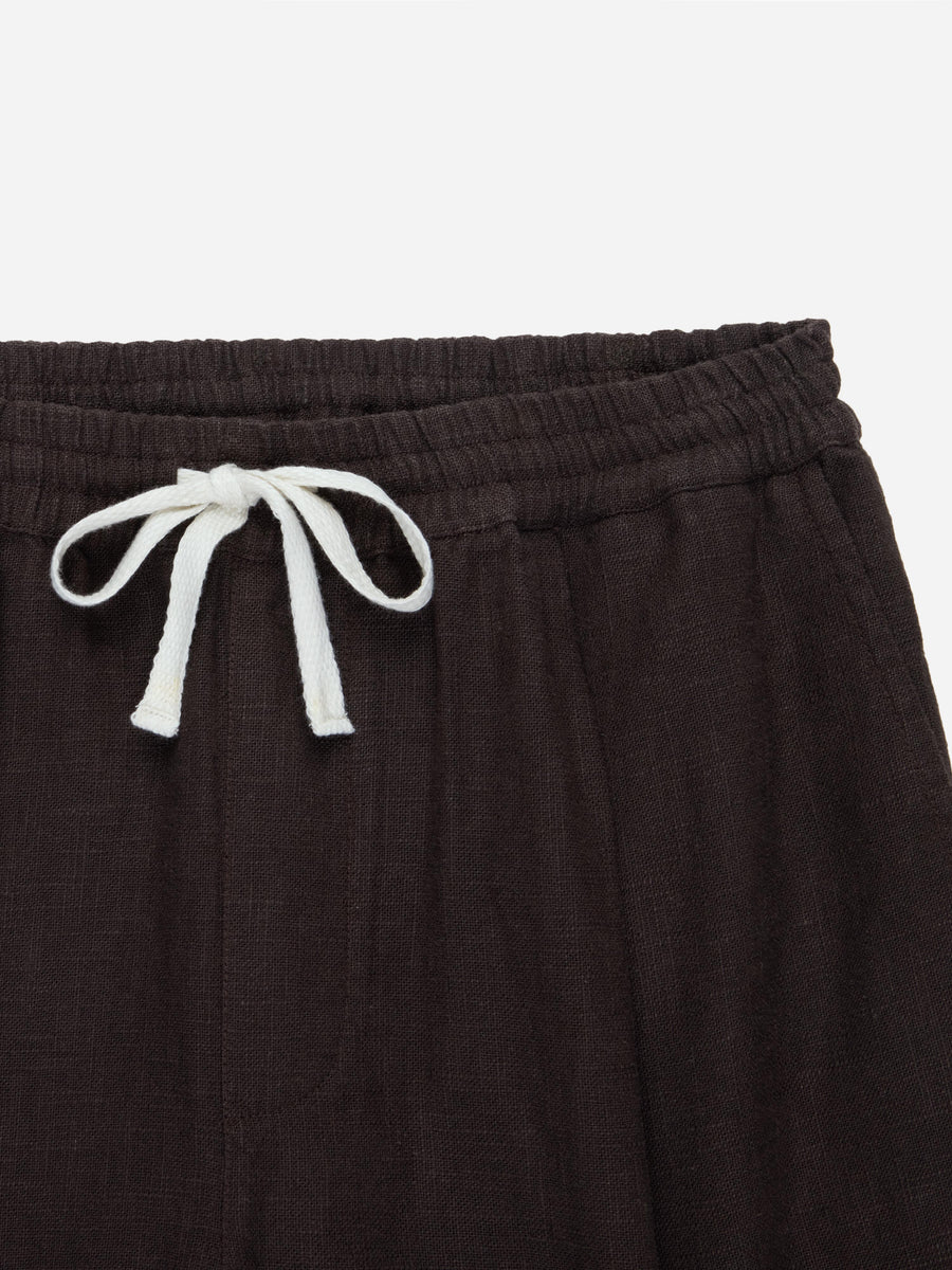 Brown shorts with a white drawstring on a light gray background