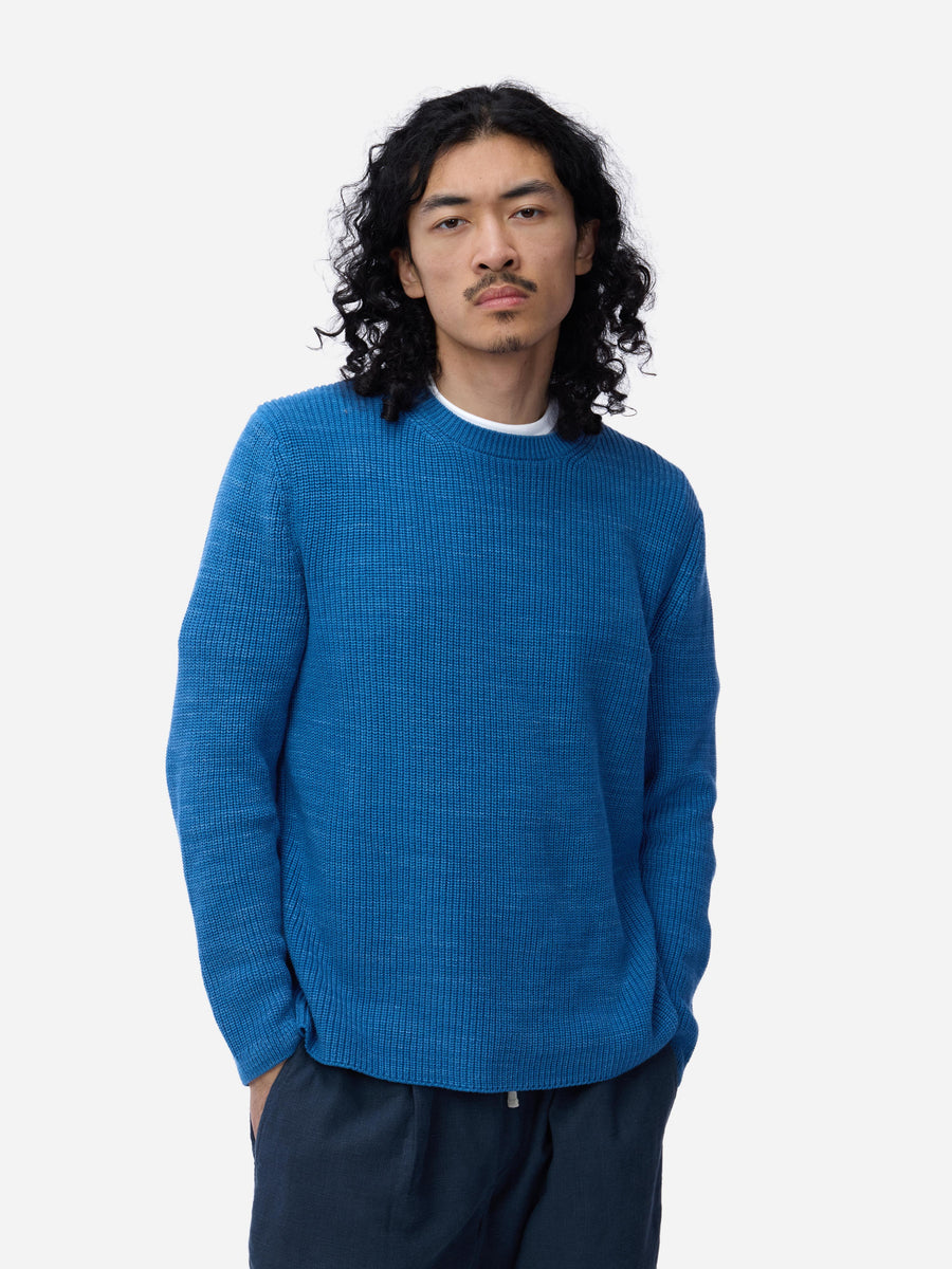 Man wearing a blue sweater on a white background