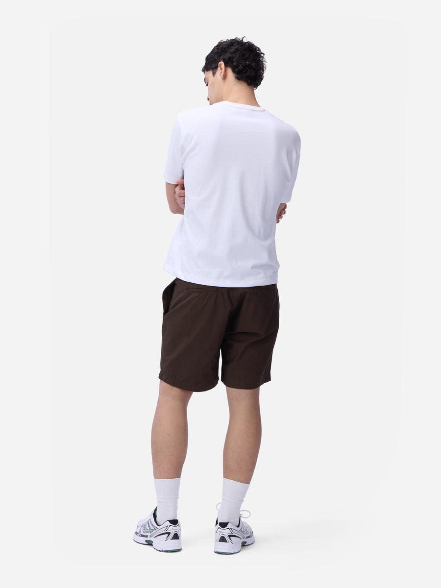Person wearing a white t-shirt and brown shorts on a white background