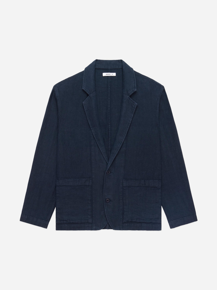 Navy blazer on a light gray background