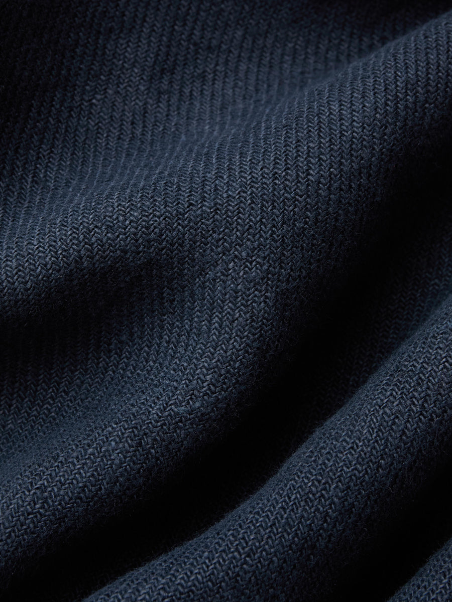 Close-up of dark blue fabric with a textured pattern