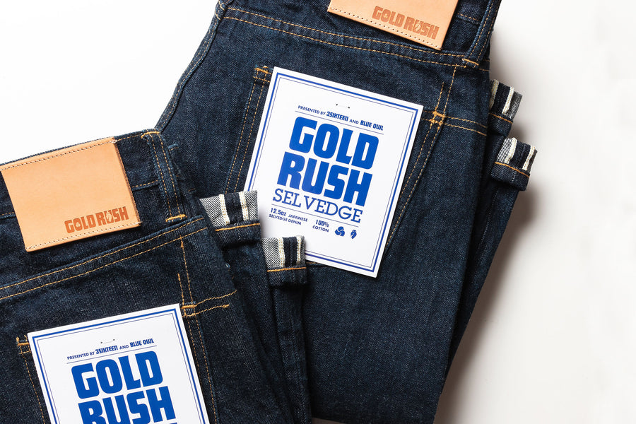 Two folded jeans on a white seamless background.