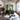 A view of our storefront featuring brick walls, wooden fixtures and assorted clothing.