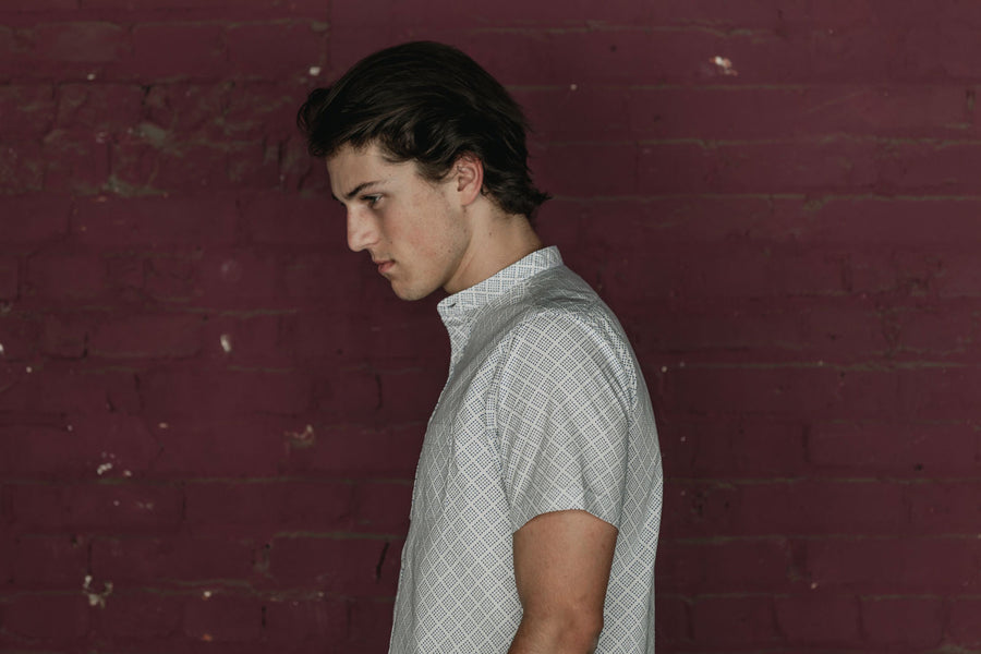 Profile shot of man wearing band collar shirt