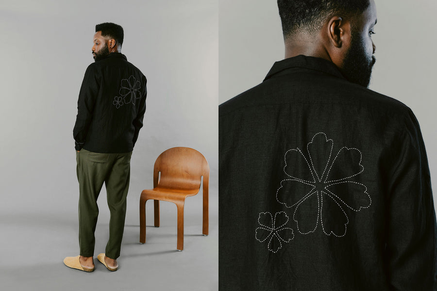 A man in a black shirt and olive pants.