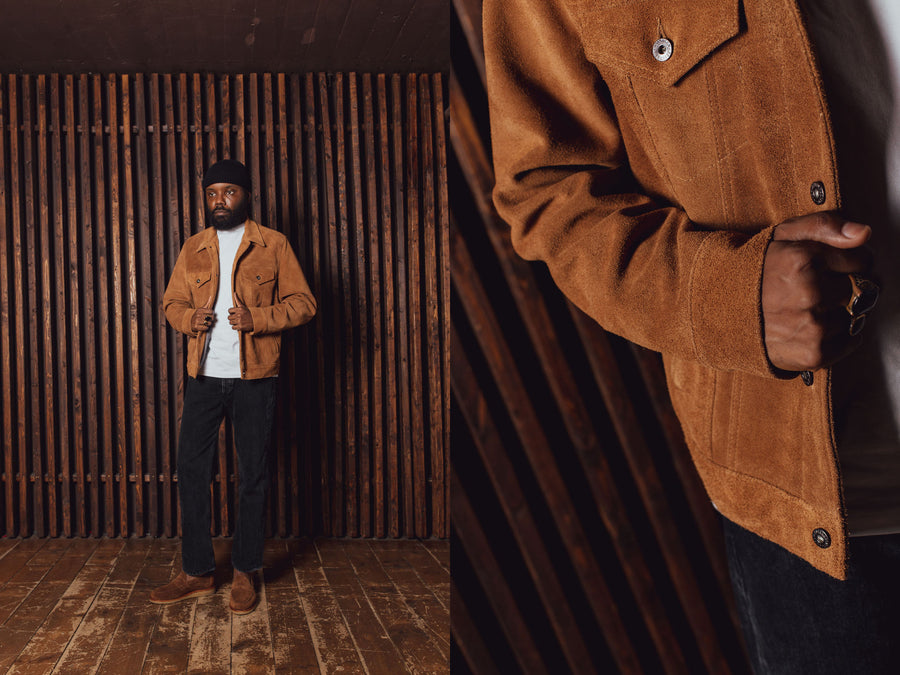 A man in a suede trucker jacket and black jeans.