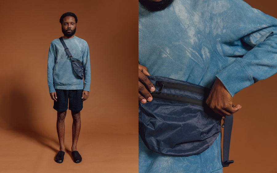 A man in a blue sweatshirt and shorts 