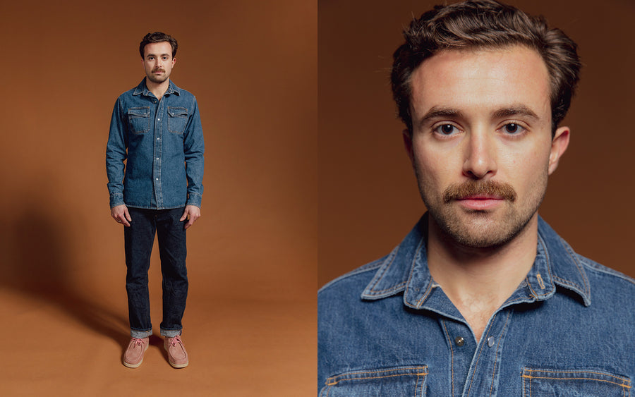 A man in a denim western shirt and blue jeans.