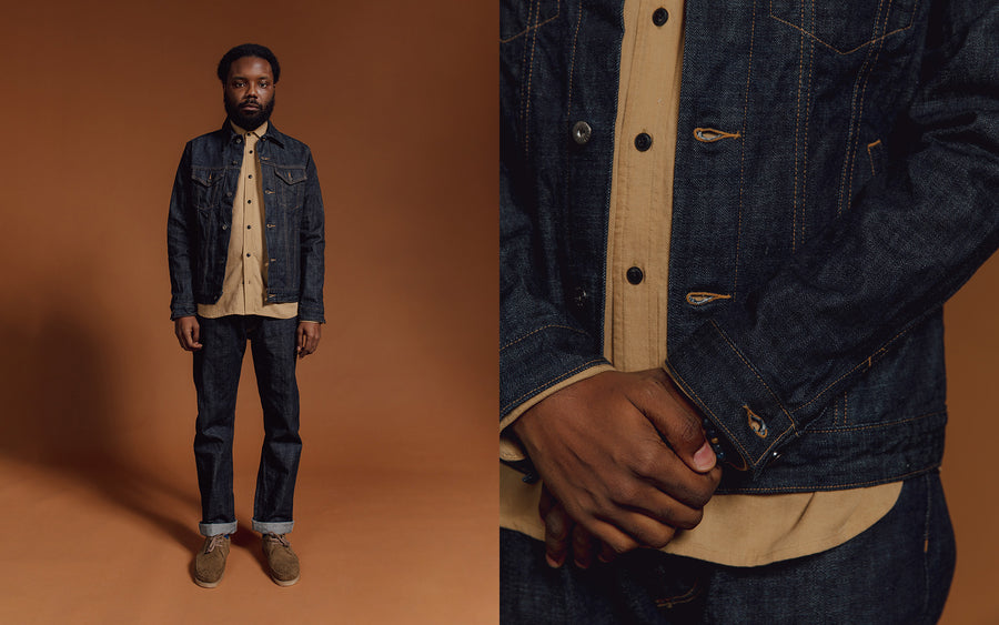 A man in a denim jacket and jeans.