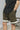 A close up of a black baseball shirt and olive shorts.