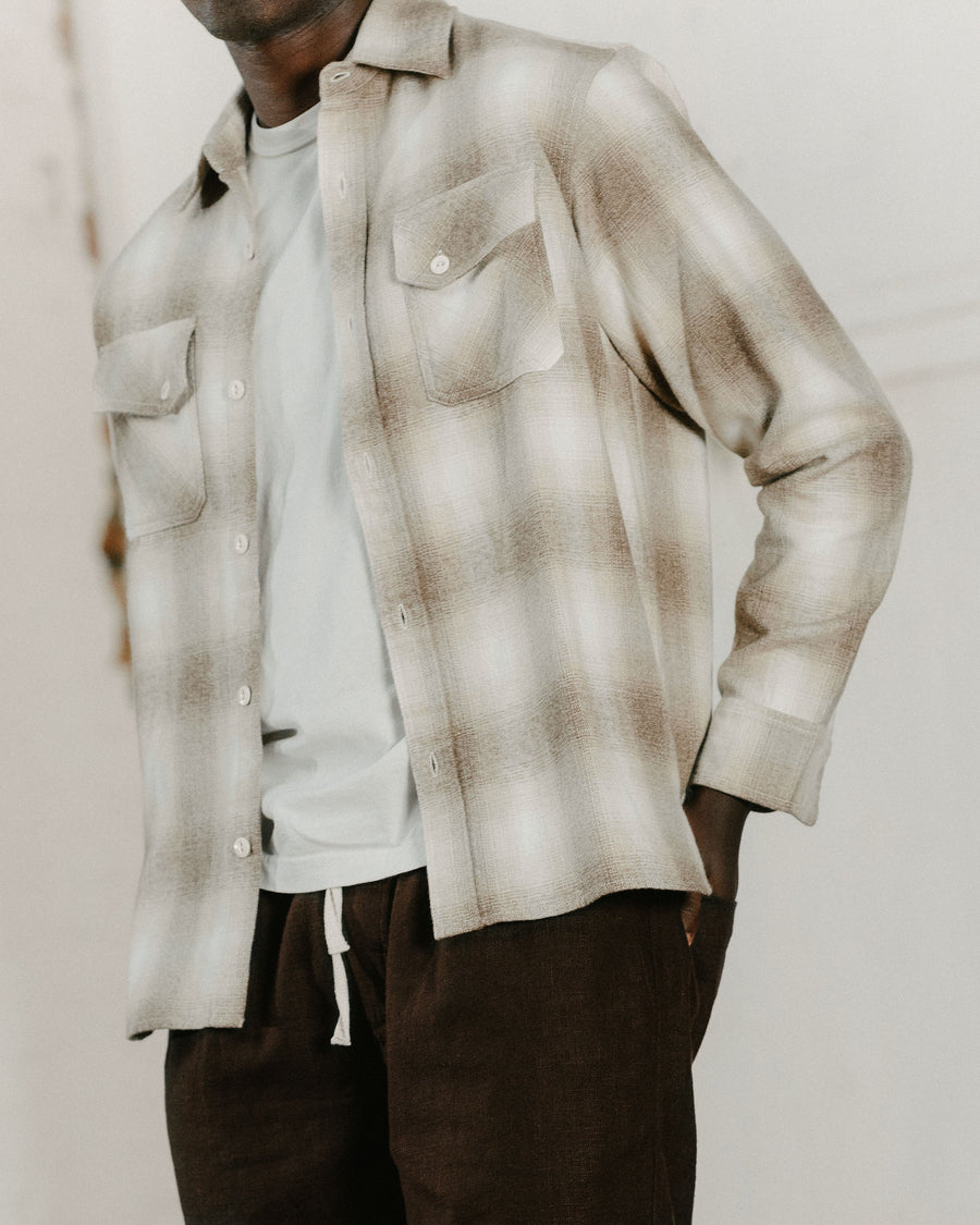 A detail image of a white and tan plaid flannel.