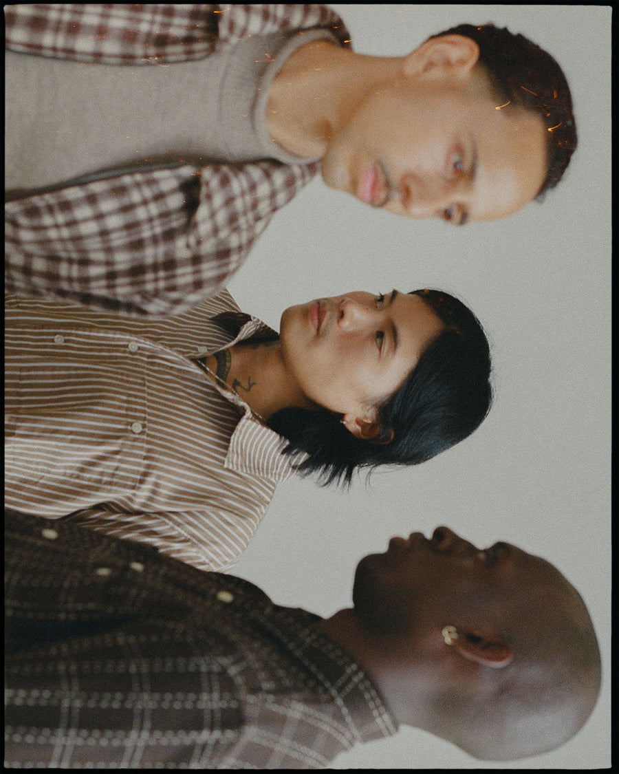 A trio of handsome guys in brown shirts.