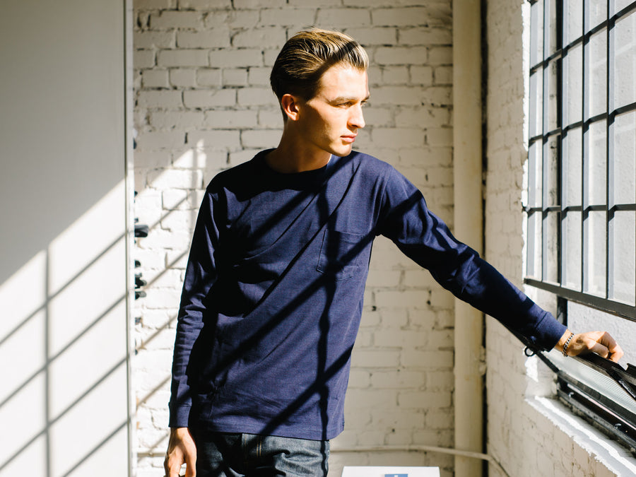 Man wearing indigo long sleeve shirt.