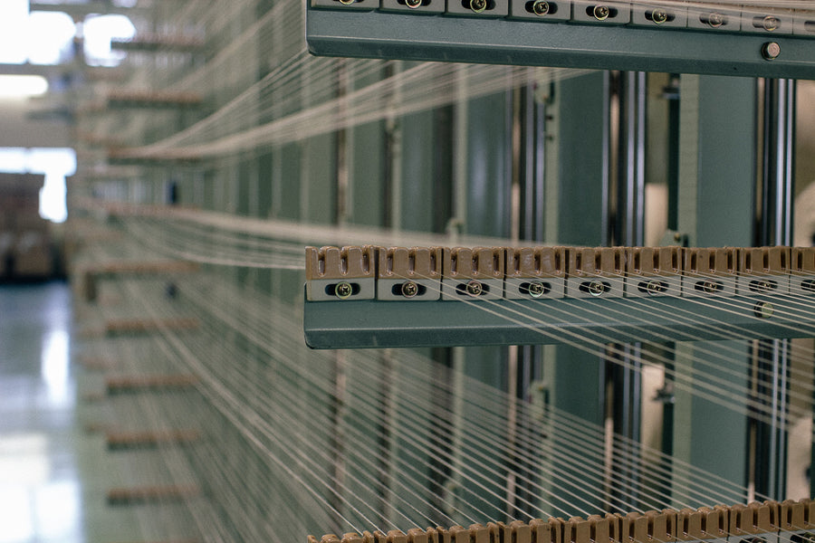 Undyed cotton threads on a loom