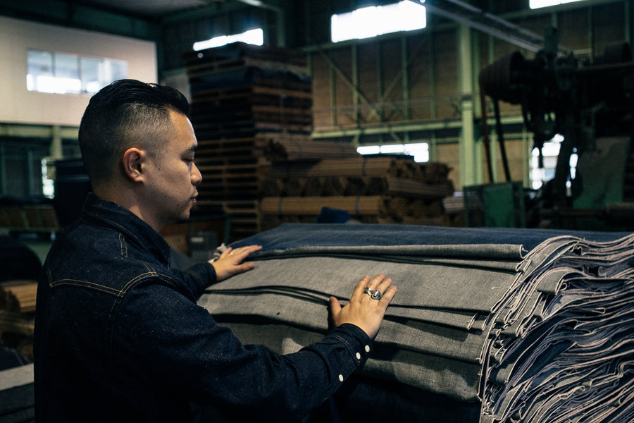 Johan Lam inspecting the finished rolls of denim.