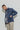 Model wears a plaid madras shirt under a Ranch Jacket with tan khakis.