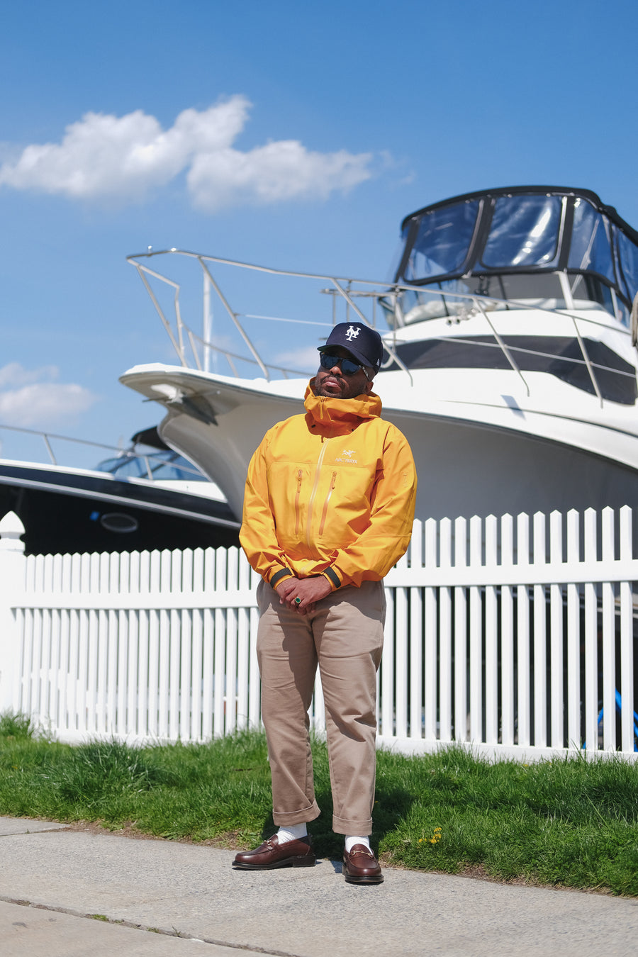 Chris Echevarria in a yellow jacket standing by some boats.