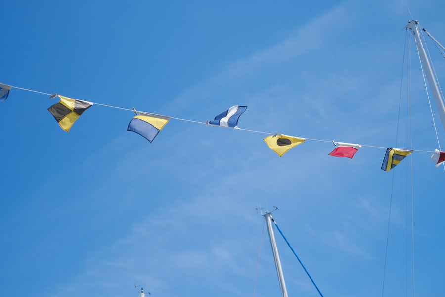 Nautical flags wave in the sky.