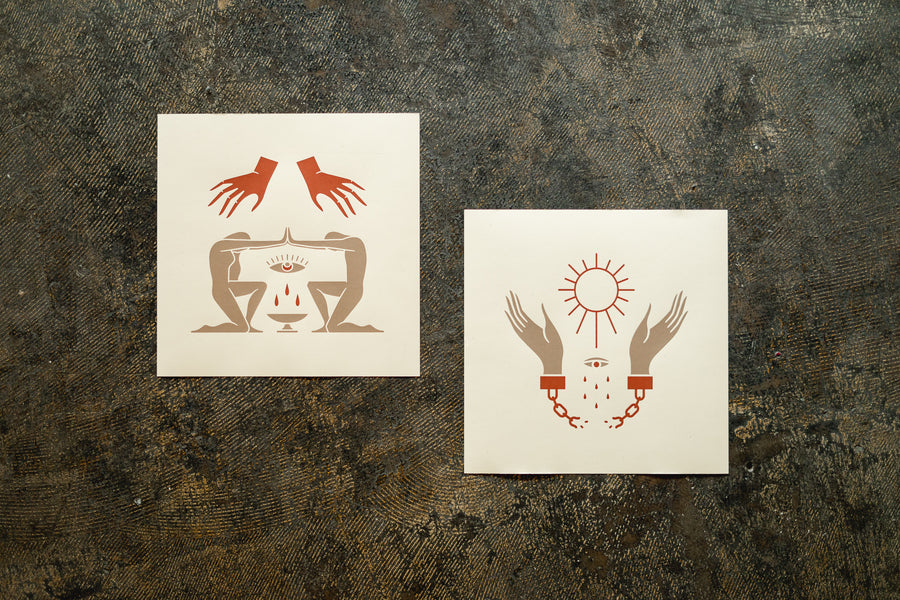 Two silkscreen prints lay on the floor.