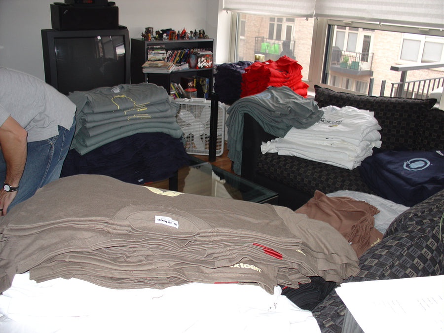 An old photo from 2004 showing stacks of 3sixteen tshirts in a living room.