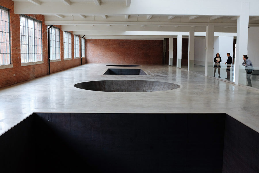Art installation showing half spheres and squares on the floor.