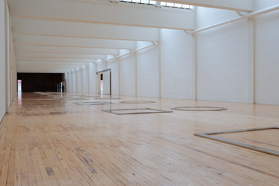 Square and circle frames on a wooden floor.