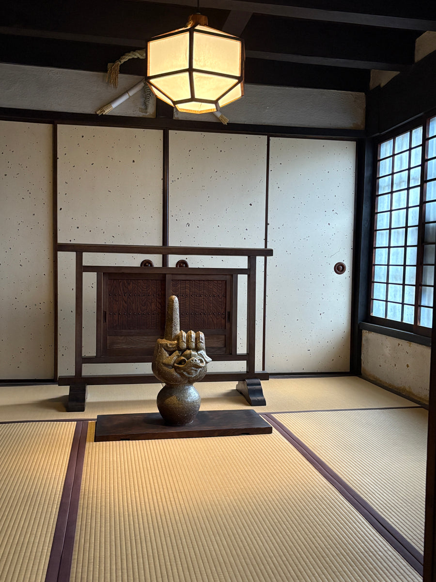 A metal sculpture in a traditional Japanese home.