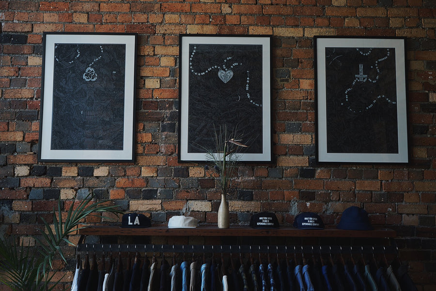 Clothes hanging on rack against brick wall.