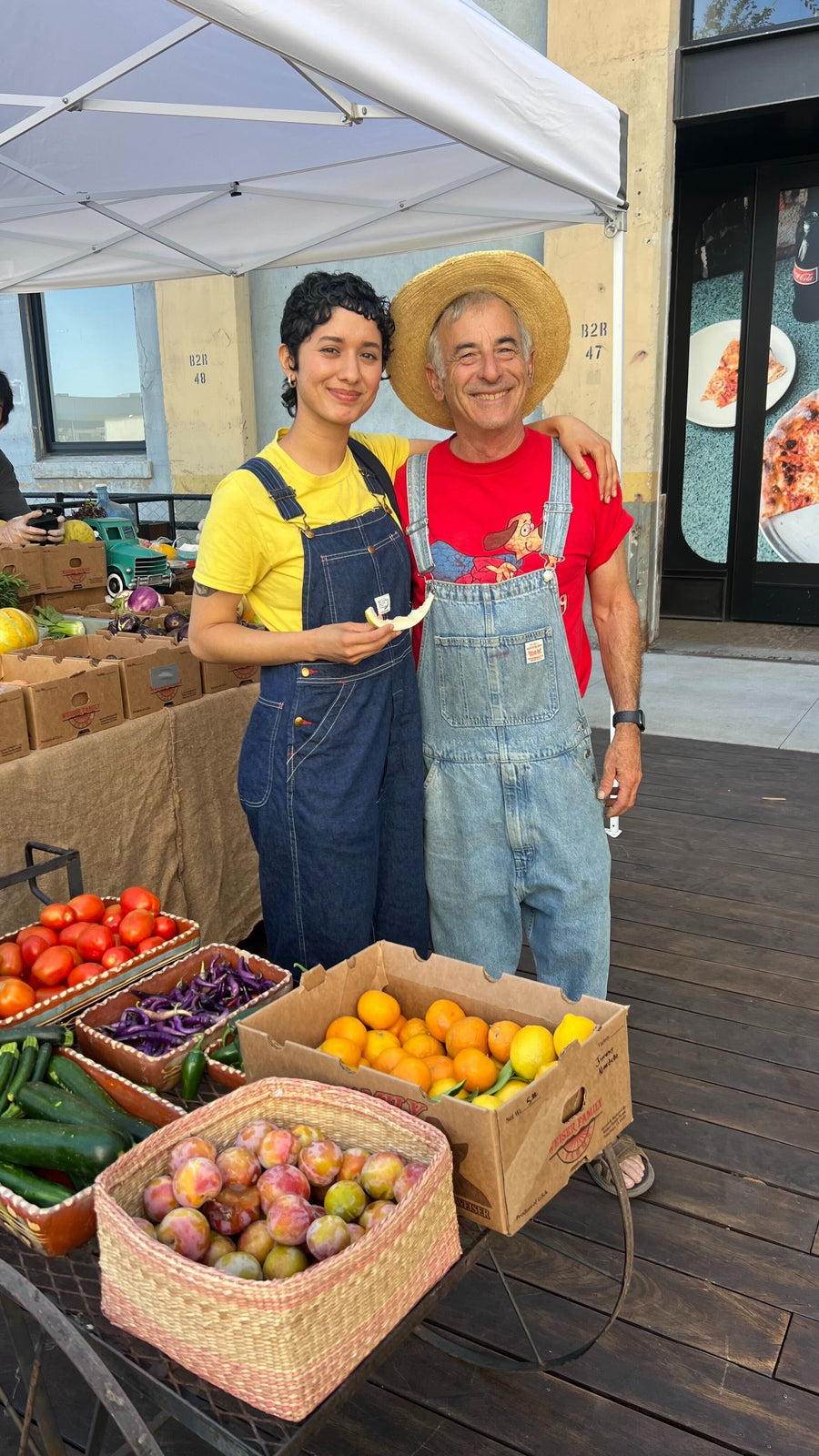 A woman and a farmer take a picture together