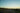 The sunset casts a golden glow over the Pacific Coast Highway.