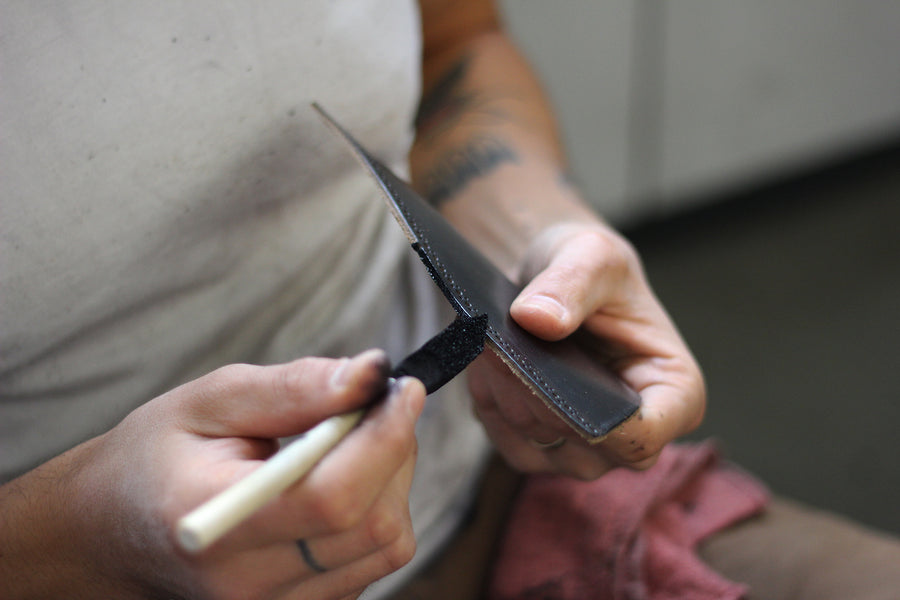 Cobbler working on some leather for boots.