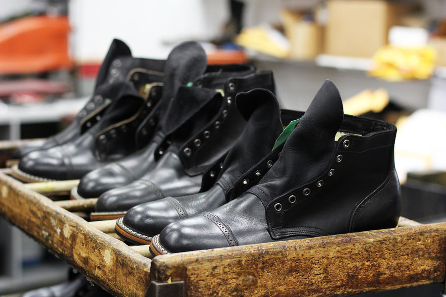 Black boots shown instead of the factory awaiting assembly.