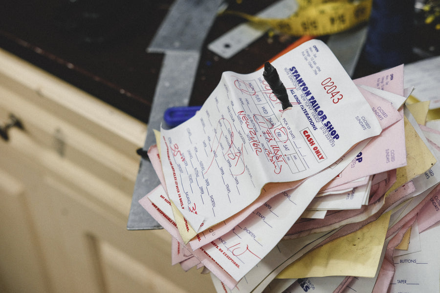 A stack of receipts on the countertop.