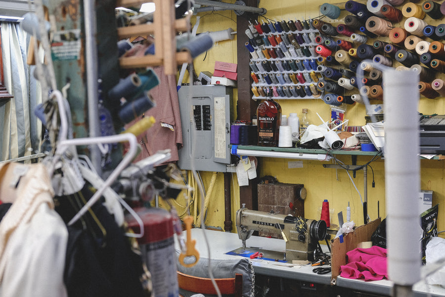 Spools of threads line the walls of the shop.
