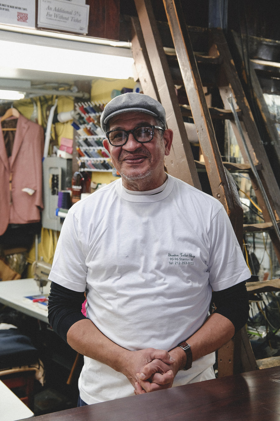 Pablo smiles into the camera in his shop.