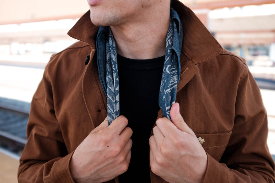 Model wearing the capsule work jacket with a bandana around his neck.