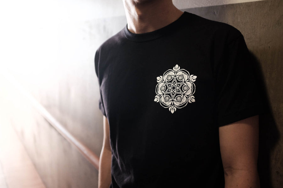 Model shown wearing the black t-shirt with a Japanese yellow rose design on the chest.