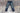 Shot of a well-worn pair of SL-120x denim on a paint-splattered concrete background.