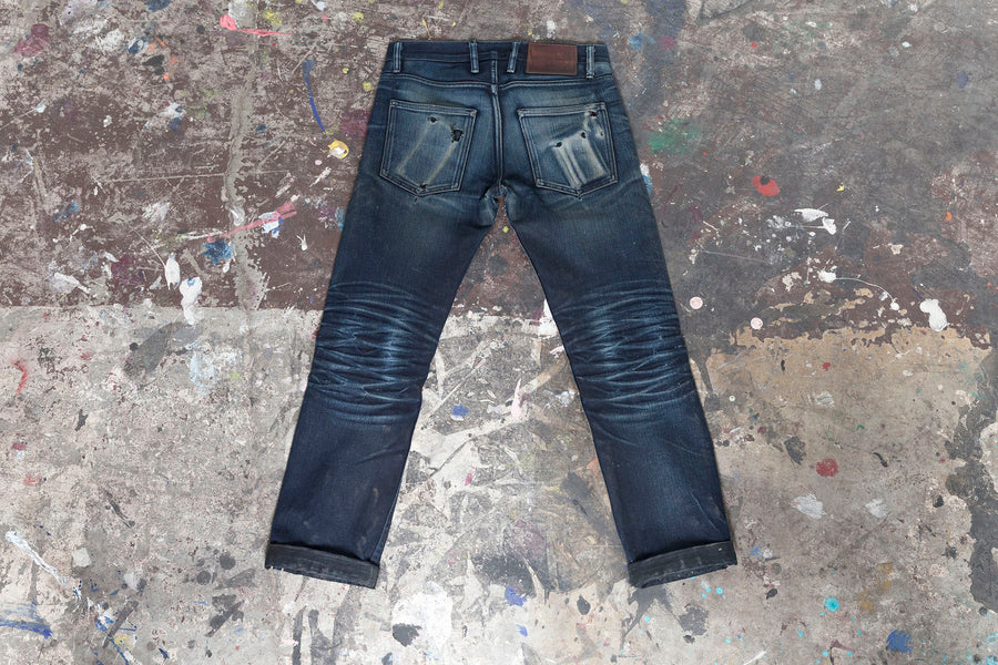 Rear shot of a pair of SL-120x denim showcasing phone and wallet fades on the rear pockets.