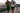 Two men run quickly with blur lines.