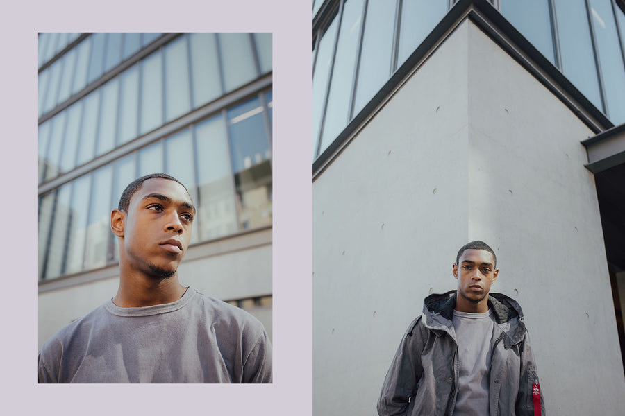 A portrait of a young man in a grey tee.