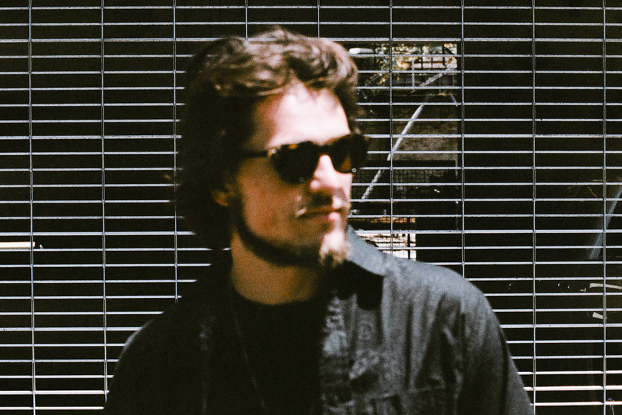 An out of focus photo of a man in sunglasses.