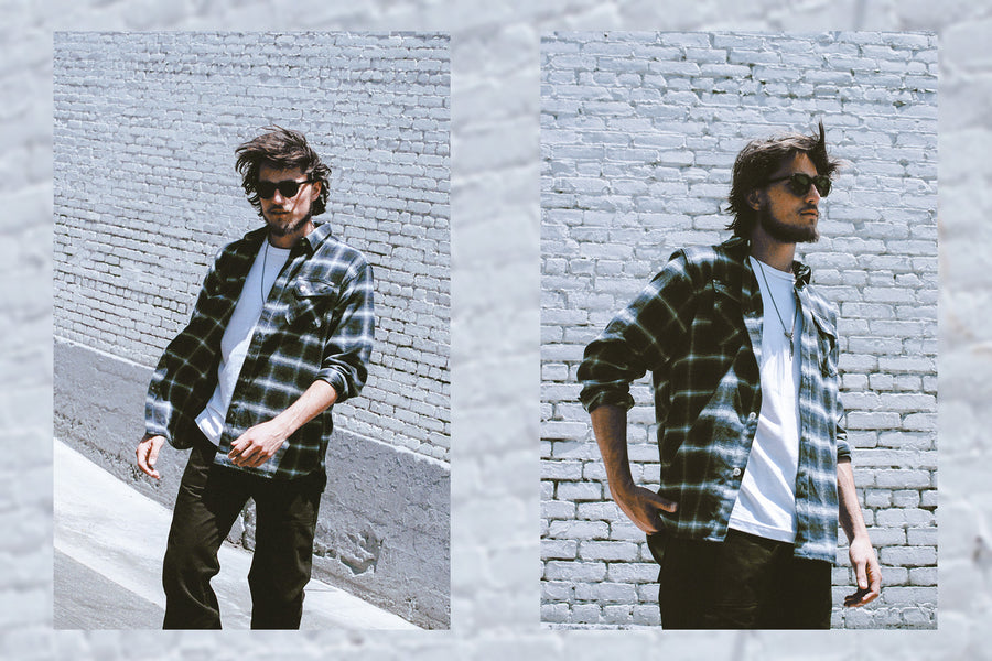 The breeze blows the man's flannel and hair sideways.