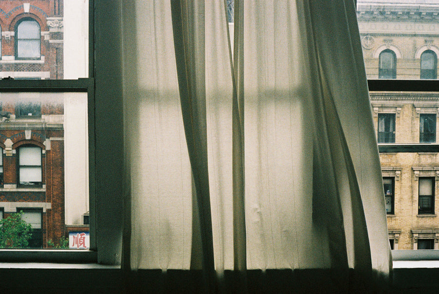 Drapes blow lazily in the wind